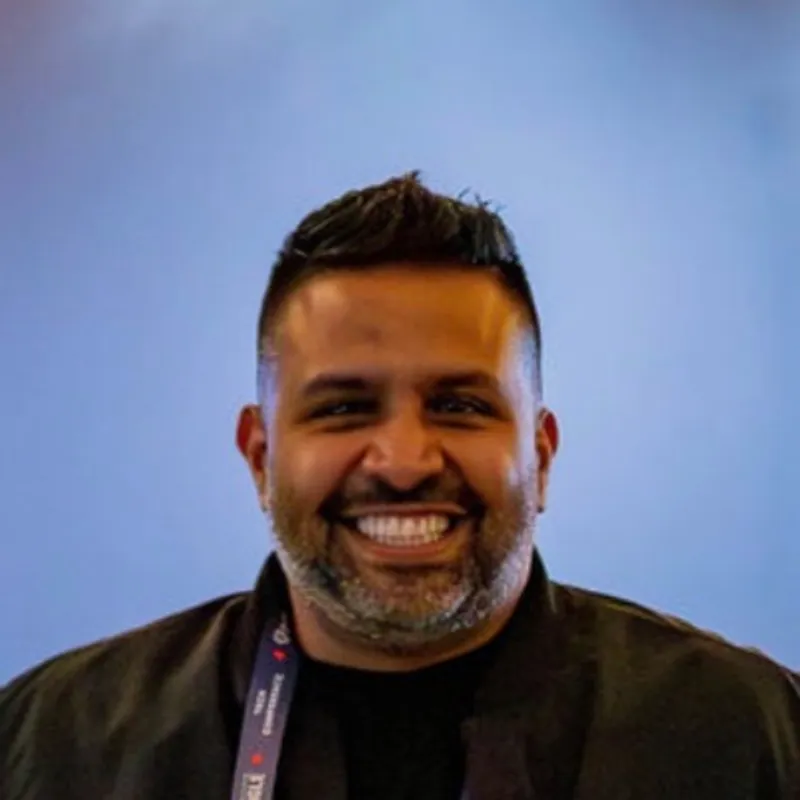 Retrato de Edgar Hernández, sonriendo, con chaqueta negra